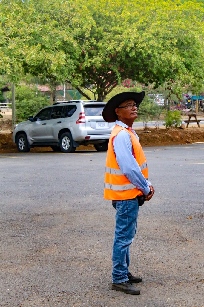 Costa Rican man wearing orange safety vest.